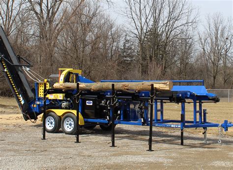 After placing the logs on the processors arms this machine takes control of the rest. . Used firewood processor